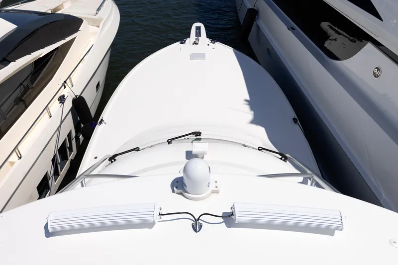 Slide: The Image of Top view of a 2017 Viking 52 Sport Tower yacht docked between two boats. - 73