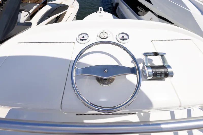Slide: The Image of Steering wheel and controls of a 2017 Viking 52 Sport Tower yacht. - 74