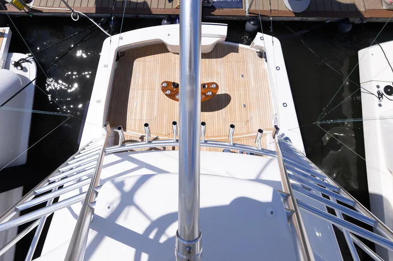 Slide: The Image of 2017 Viking 52 Sport Tower yacht deck view from above, docked at marina. - 75