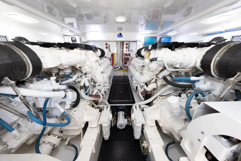 Slide: The Image of Engine room of 2017 Viking 52 Sport Tower yacht, showcasing dual engines and mechanical systems. - 76