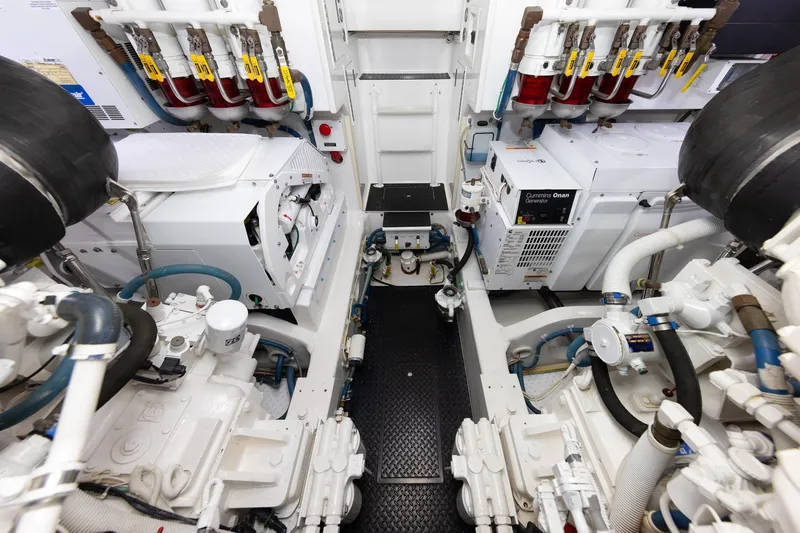 Slide: The Image of Engine room of a 2017 Viking 52 Sport Tower yacht, featuring Cummins Onan generator. - 77