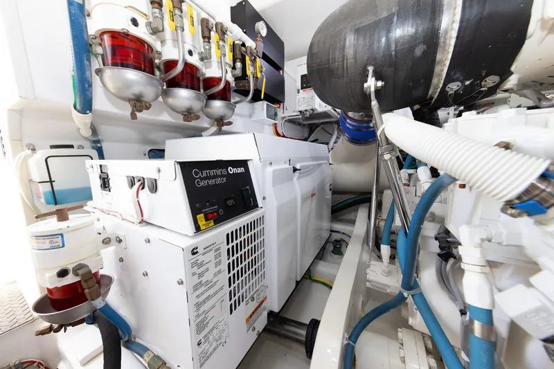 Slide: The Image of Engine room of 2017 Viking 52 Sport Tower with Cummins Onan generator and fuel filters. - 78