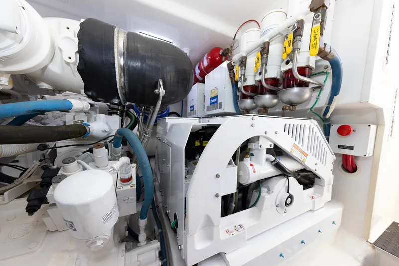 Slide: The Image of Engine room of 2017 Viking 52 Sport Tower with mechanical components and piping. - 79