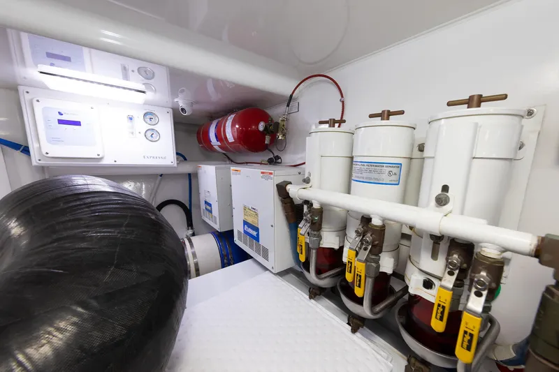 Slide: The Image of Engine room of 2017 Viking 52 Sport Tower with fuel filters and fire suppression system. - 80