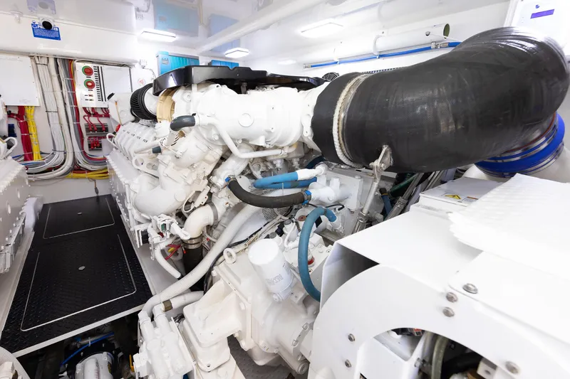 Slide: The Image of Engine room of a 2017 Viking 52 Sport Tower yacht, showcasing complex machinery and wiring. - 83
