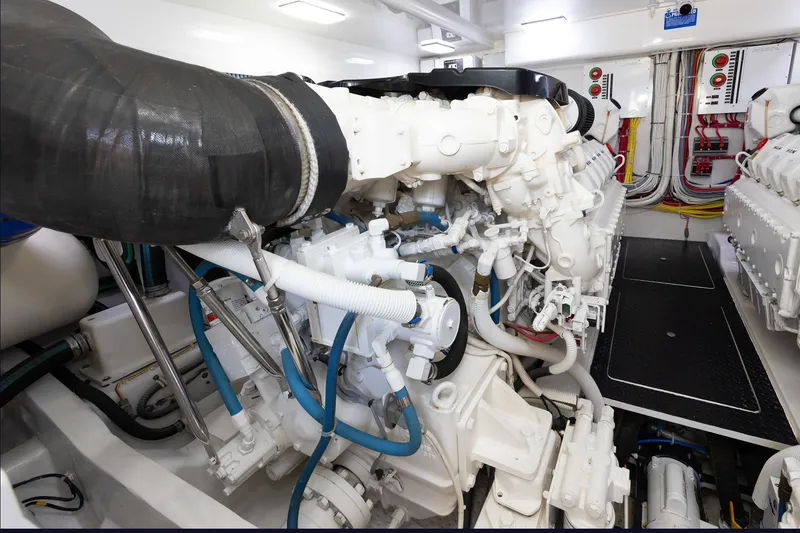 Slide: The Image of Engine room of a 2017 Viking 52 Sport Tower yacht, showcasing complex machinery and wiring. - 84