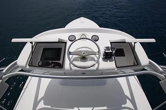 Slide: The Image of 2017 Viking 52 Sport Tower yacht on calm water under blue sky. - 9