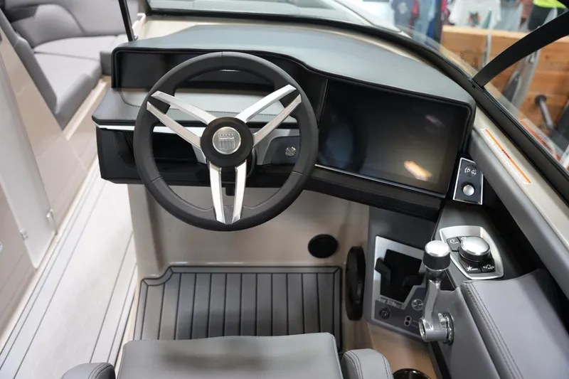 Slide: The Image of 2025 MasterCraft XT22 boat cockpit with modern steering wheel and control panel. - 10
