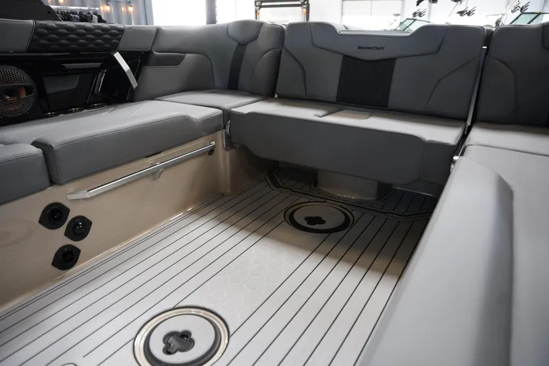 Slide: The Image of Interior of 2025 MasterCraft XT22 boat with sleek gray seating and modern design. - 11