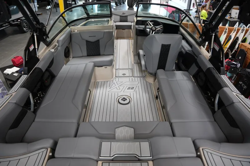 Slide: The Image of 2025 MasterCraft XT22 boat interior with gray seating and sleek design. - 13