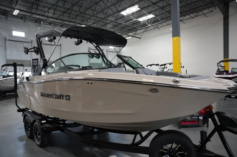 Slide: The Image of 2025 MasterCraft XT22 boat in showroom, featuring sleek design and modern amenities. - 5