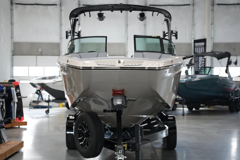 Slide: The Image of 2025 MasterCraft XT22 boat in showroom, front view on trailer. - 6