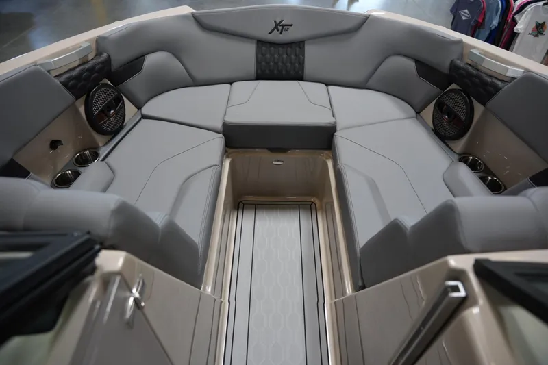 Slide: The Image of 2025 MasterCraft XT22 boat interior with gray seating and cup holders. - 8
