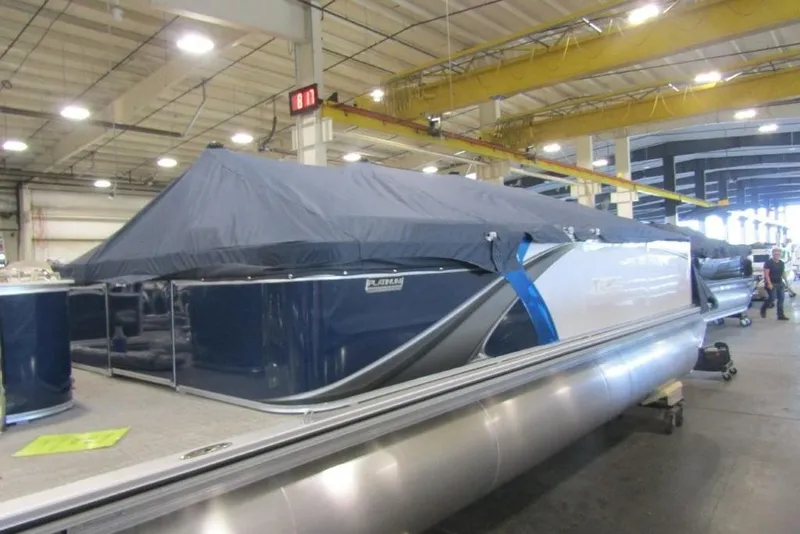 The Image of 2026 Tahoe Pontoon LTZ Quad Lounger 23 in a warehouse, covered with a protective tarp. - 1