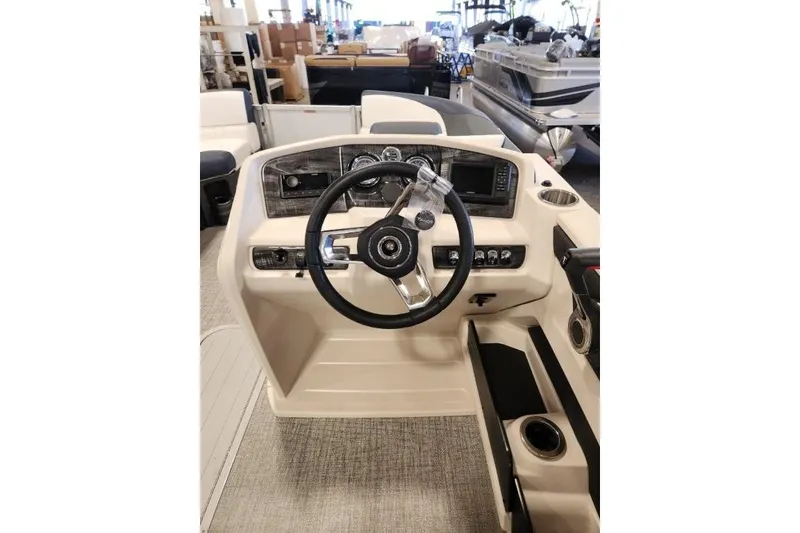 Slide: The Image of Steering console of 2026 Tahoe Pontoon LTZ Quad Lounger 23 in showroom. - 10