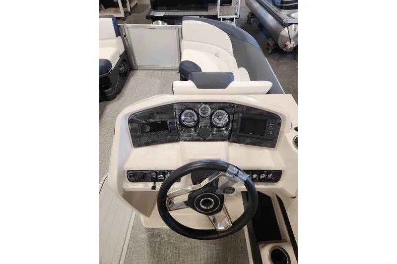 Slide: The Image of 2026 Tahoe Pontoon LTZ Quad Lounger 23 dashboard with steering wheel and controls. - 11