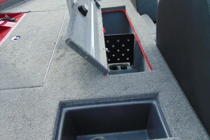 Slide: The Image of 2024 Tracker Pro Team 175 TF boat storage compartments with open lids, showcasing interior design. - 12