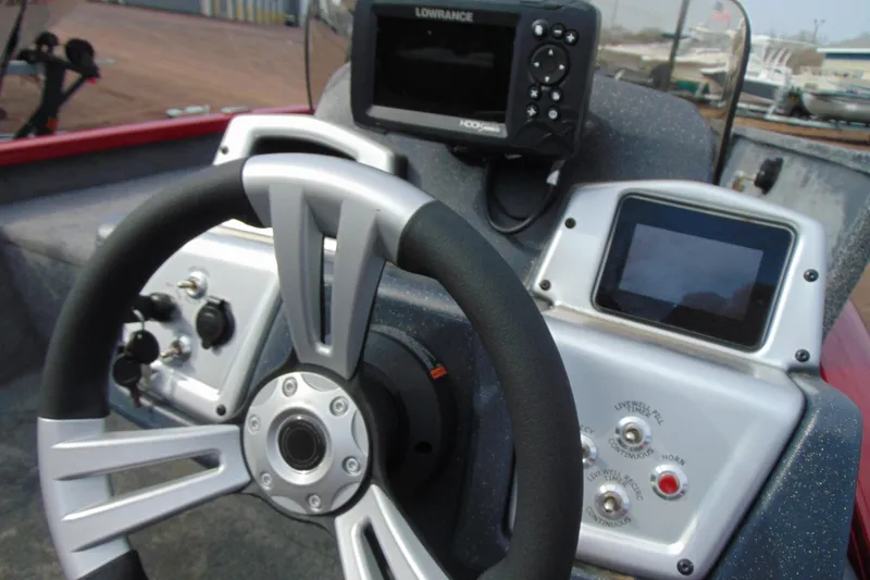 Slide: The Image of 2024 Tracker Pro Team 175 TF boat dashboard with steering wheel and electronic displays. - 13
