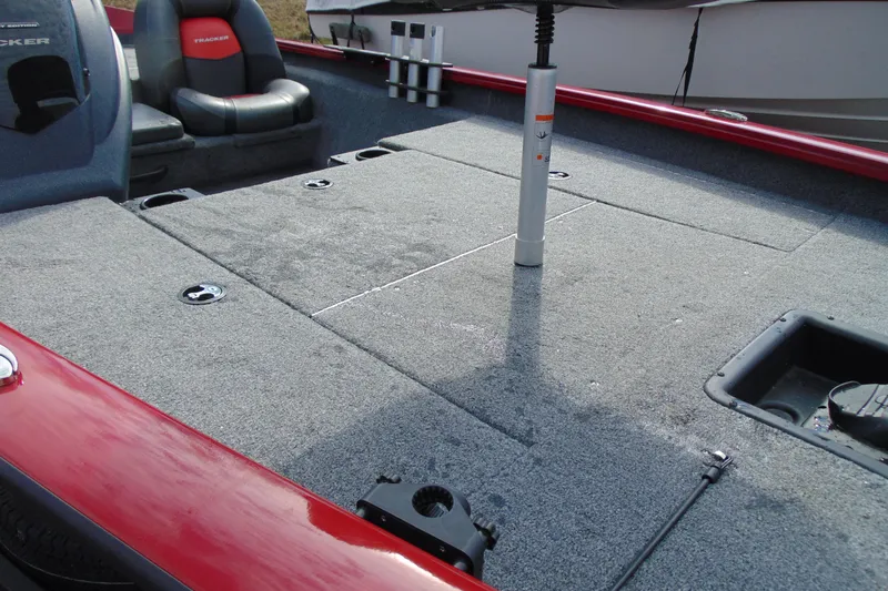 Slide: The Image of 2024 Tracker Pro Team 175 TF boat interior with carpeted deck and seating. - 5