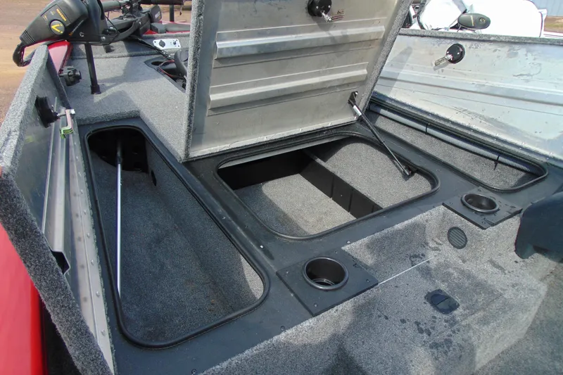 Slide: The Image of 2024 Tracker Pro Team 175 TF boat interior with open storage compartments. - 6