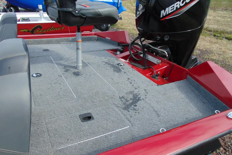 Slide: The Image of 2024 Tracker Pro Team 175 TF boat deck with Mercury engine, featuring gray carpet and seating. - 8