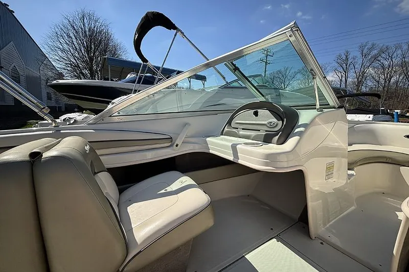 Slide: The Image of Interior of a 2004 Sea Ray 185 Sport boat with steering wheel and seating. - 10