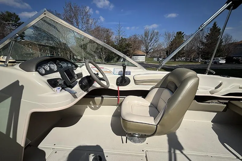 Slide: The Image of 2004 Sea Ray 185 Sport boat interior with steering wheel and dashboard controls. - 12