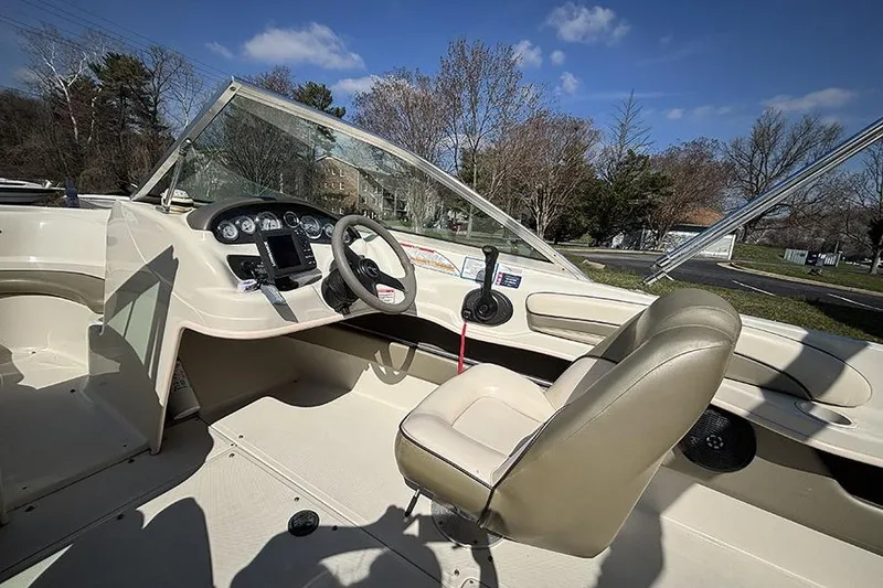 Slide: The Image of 2004 Sea Ray 185 Sport boat interior with steering wheel and dashboard controls. - 13