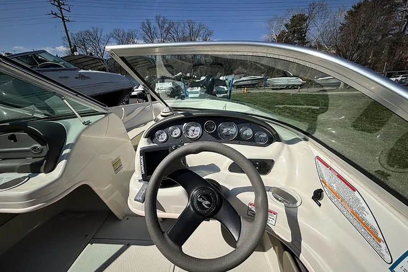 Slide: The Image of 2004 Sea Ray 185 Sport boat dashboard with steering wheel and gauges. - 14