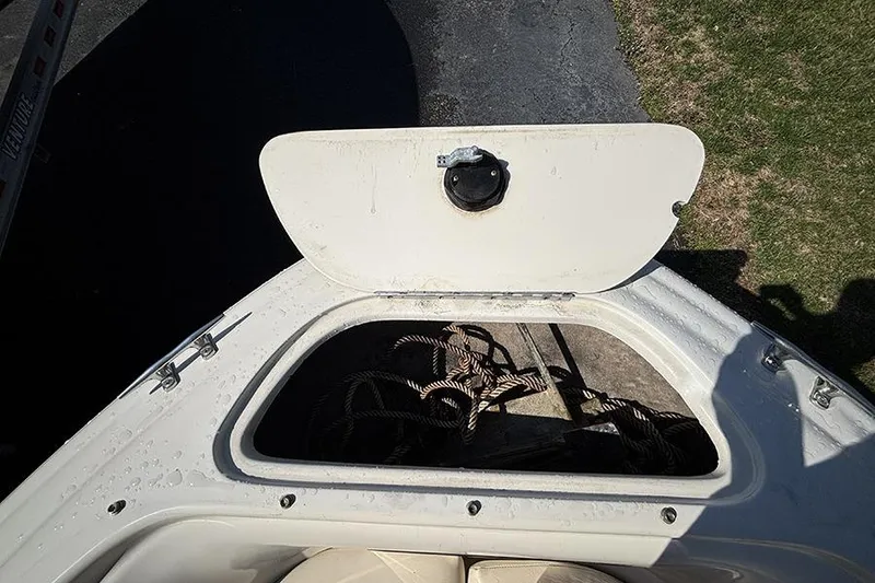 Slide: The Image of Open storage compartment on 2004 Sea Ray 185 Sport boat with ropes inside. - 18