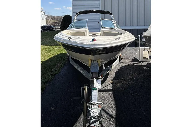 Slide: The Image of 2004 Sea Ray 185 Sport boat on trailer, parked outdoors. - 2