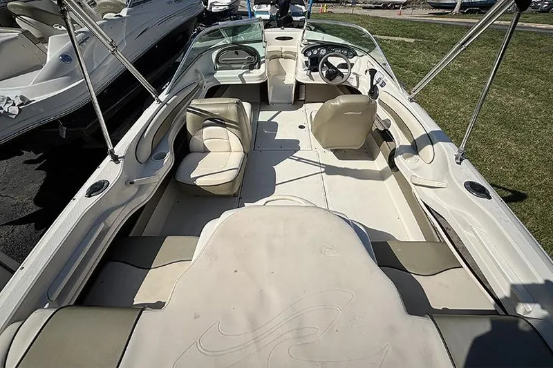 Slide: The Image of 2004 Sea Ray 185 Sport boat interior with seating and steering wheel. - 5