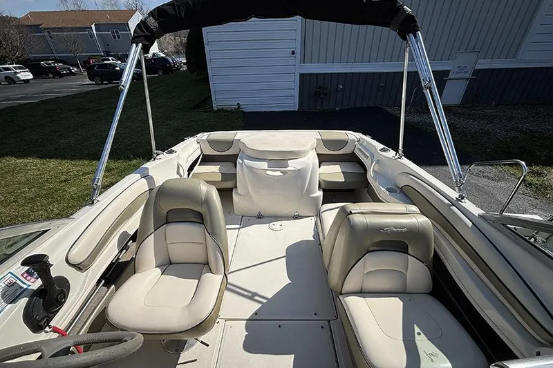 Slide: The Image of 2004 Sea Ray 185 Sport boat interior with beige seating and canopy. - 7