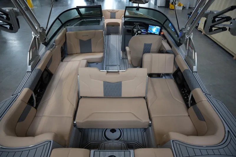 Slide: The Image of 2025 MasterCraft XT23 boat interior with luxurious seating and modern dashboard. - 13
