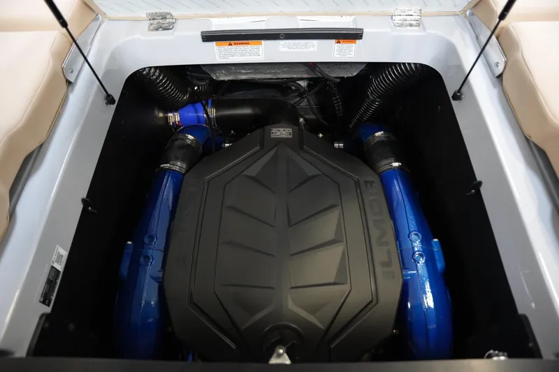 Slide: The Image of 2025 MasterCraft XT23 engine compartment with blue accents and black cover. - 15