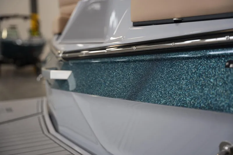 Slide: The Image of 2025 MasterCraft XT23 boat with sparkling blue exterior detail. - 17