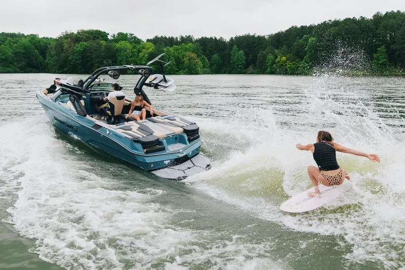 Slide: The Image of Manufacturer Provided Image: 2025 MasterCraft XT23 boat towing a wakeboarder on a lake. - 18