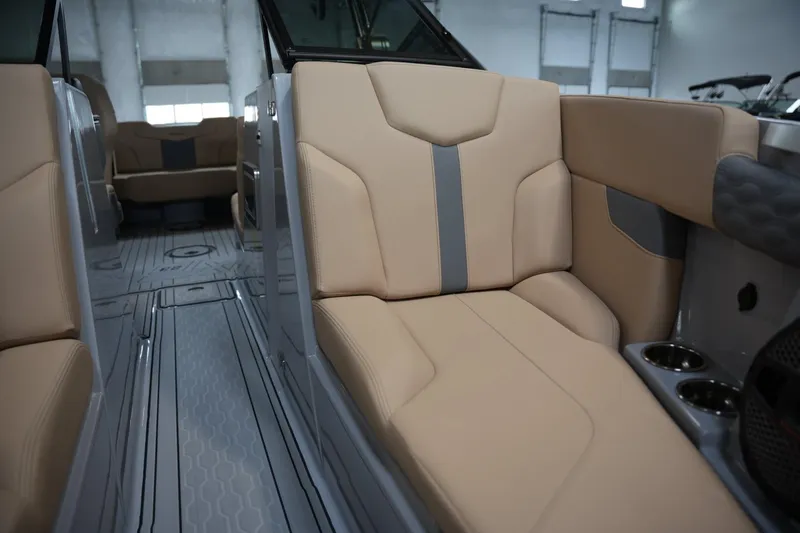 Slide: The Image of 2025 MasterCraft XT23 interior with beige seating and modern design. - 6