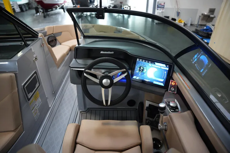 Slide: The Image of 2025 MasterCraft XT23 boat interior with modern dashboard and touchscreen controls. - 8
