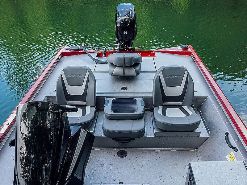 Slide: The Image of Manufacturer Provided Image: 2024 Lowe Stinger 175C fishing boat with seating and motor on a calm lake. - 16