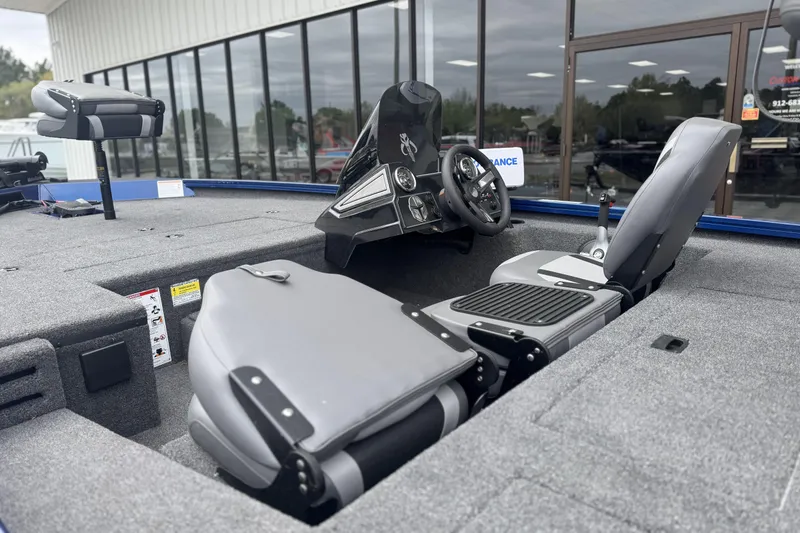 Slide: The Image of 2024 Lowe Stinger 175C boat interior with steering console and seating. - 20