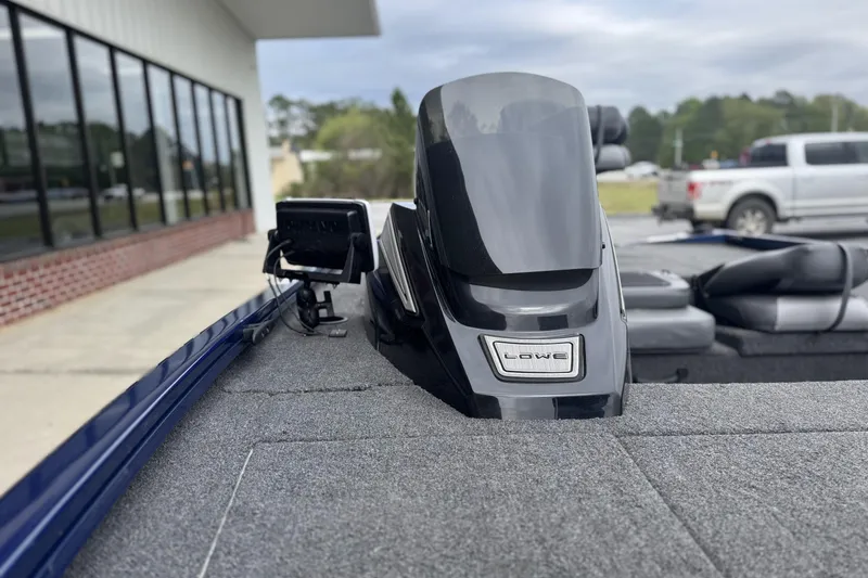 Slide: The Image of 2024 Lowe Stinger 175C boat with modern dashboard and sleek design. - 7