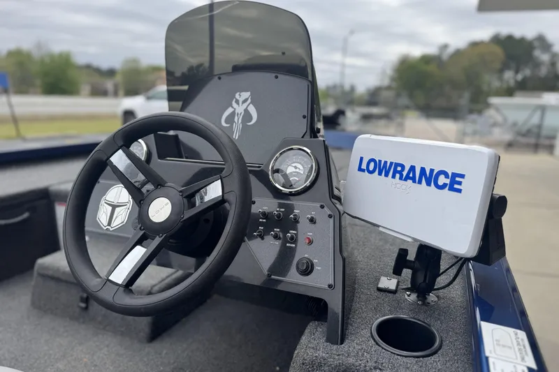 Slide: The Image of 2024 Lowe Stinger 175C boat dashboard with steering wheel and Lowrance Hook display. - 8