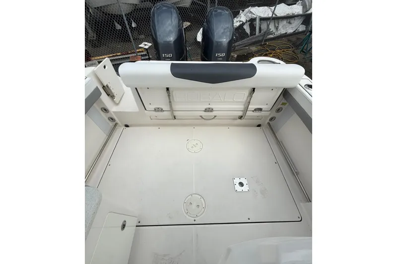 Slide: The Image of 2021 Robalo R247 Dual Console boat deck with twin 150 engines, spacious and clean design. - 10
