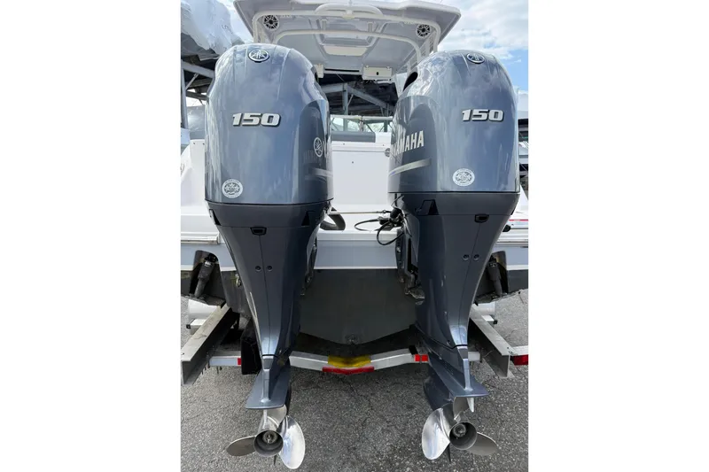 Slide: The Image of 2021 Robalo R247 Dual Console with twin Yamaha 150 outboard engines. - 15