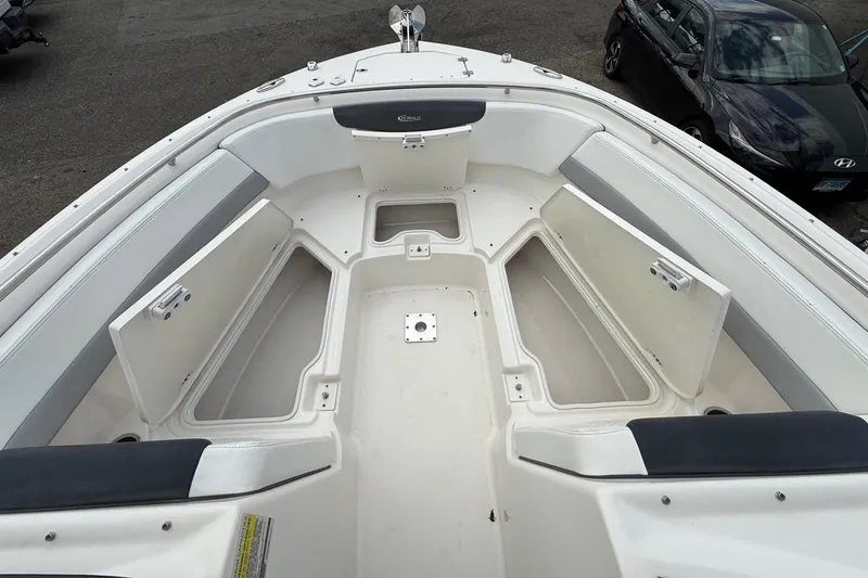 Slide: The Image of 2021 Robalo R247 Dual Console boat interior with open storage compartments. - 4
