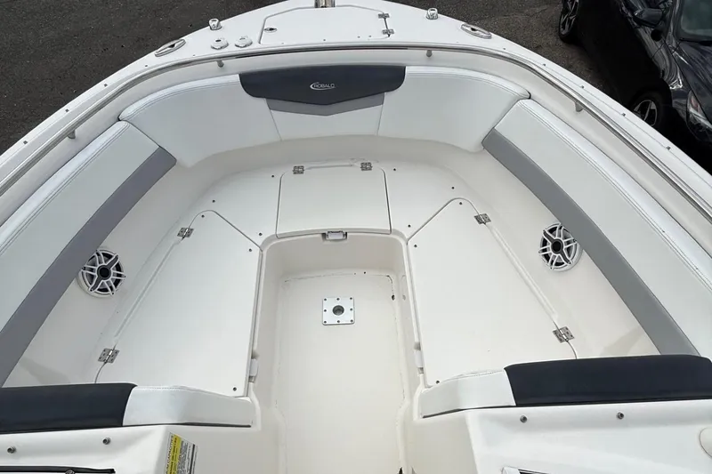Slide: The Image of 2021 Robalo R247 Dual Console boat interior with spacious seating and storage compartments. - 5
