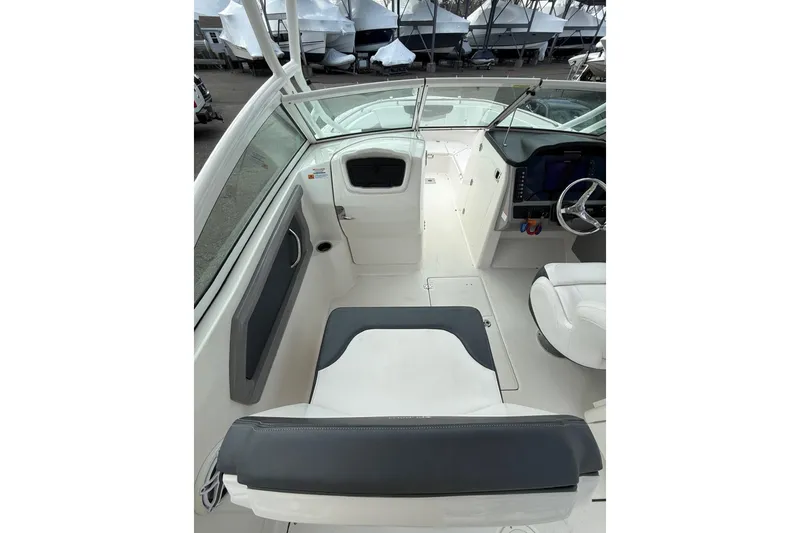 Slide: The Image of 2021 Robalo R247 Dual Console boat interior with seating and helm. - 9