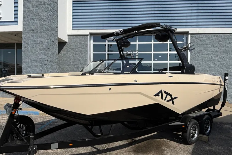 Slide: The Image of 2026 ATX Surf Boats 24 Type-S in showroom, beige and black design. - 2