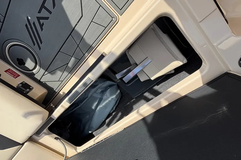 Slide: The Image of 2026 ATX Surf Boats 24 Type-S storage compartment with seat and equipment. - 32